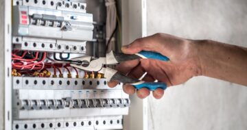 electrical-technician-working-switchboard-with-fuses electrical-technician-working-switchboard-with-fuses